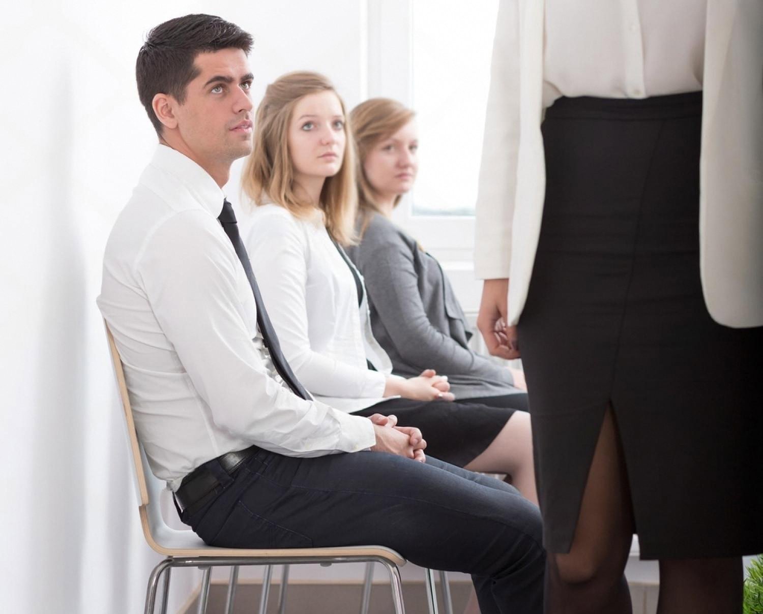 Customers seated in a UAE bank branch waiting to be called by a staff member